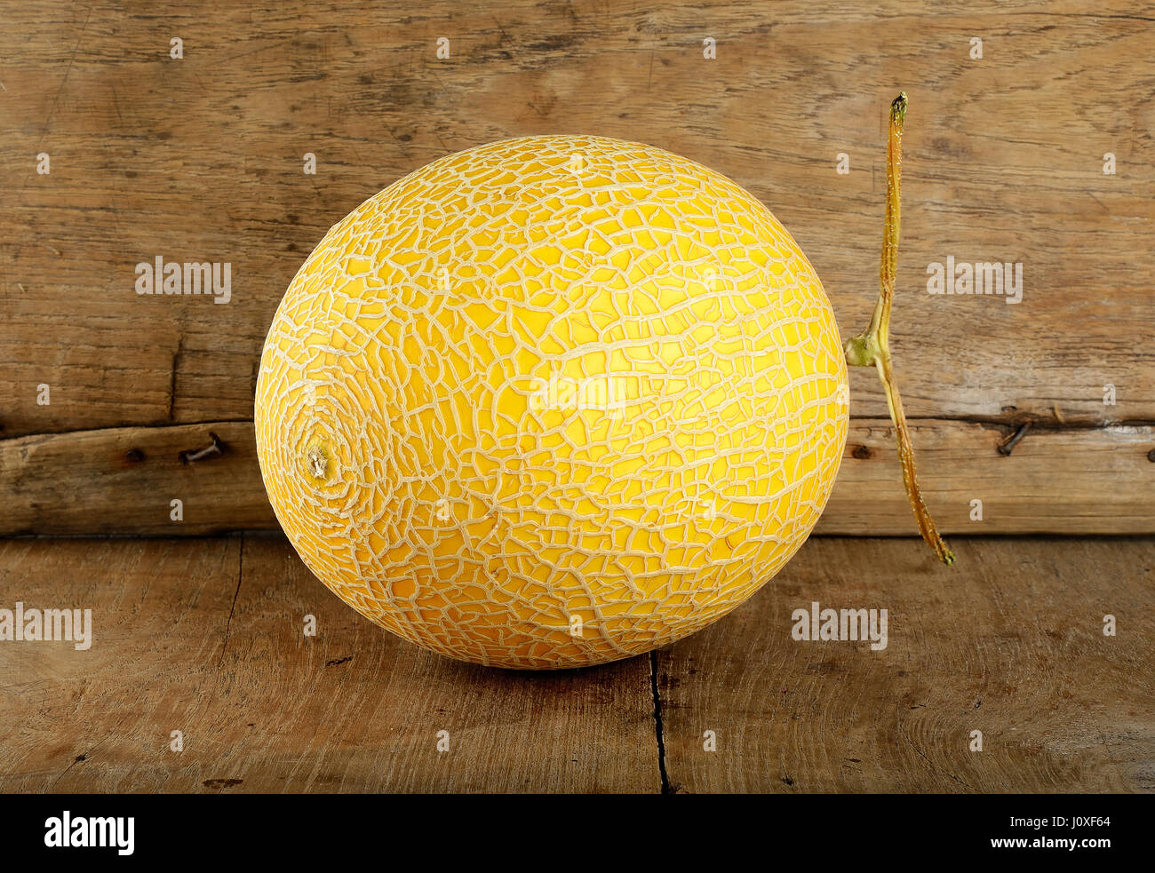 Yellow cantaloupe melon on the wooden background Stock Photo Alamy