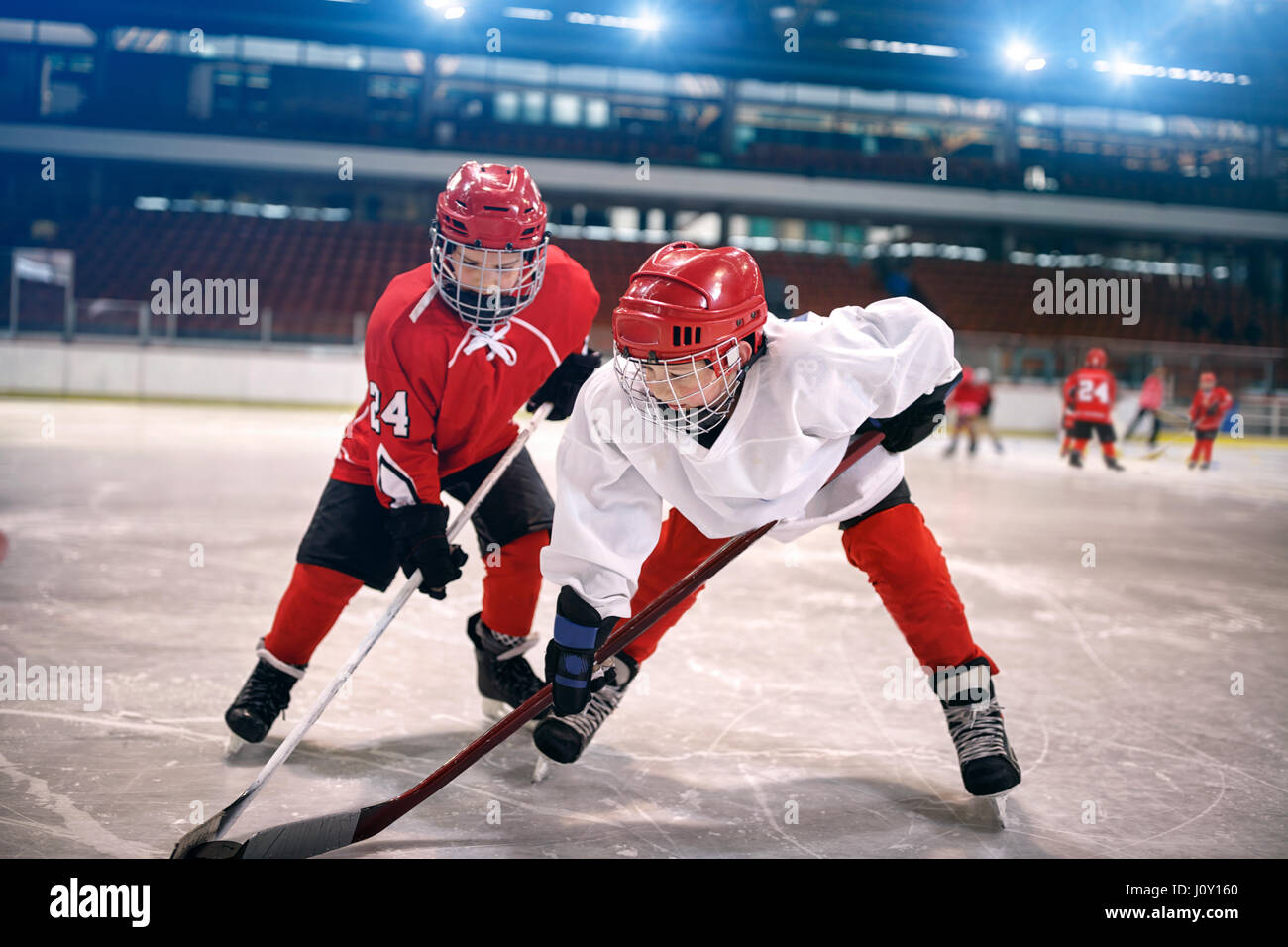 young children play ice hockey Stock Photo