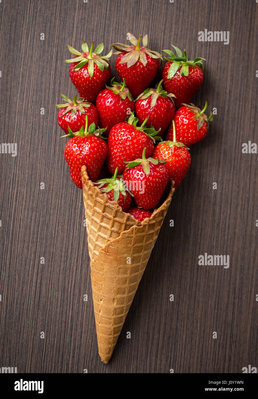 cone with fresh strawberry background Stock Photo - Alamy