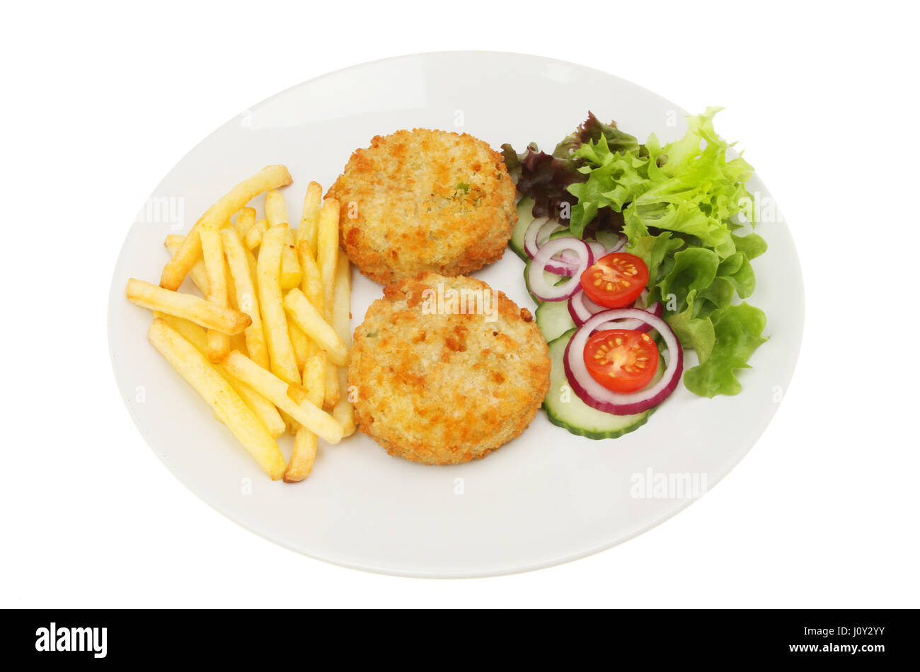 Fish cakes French fries and salad on a plate isolated against white Stock Photo