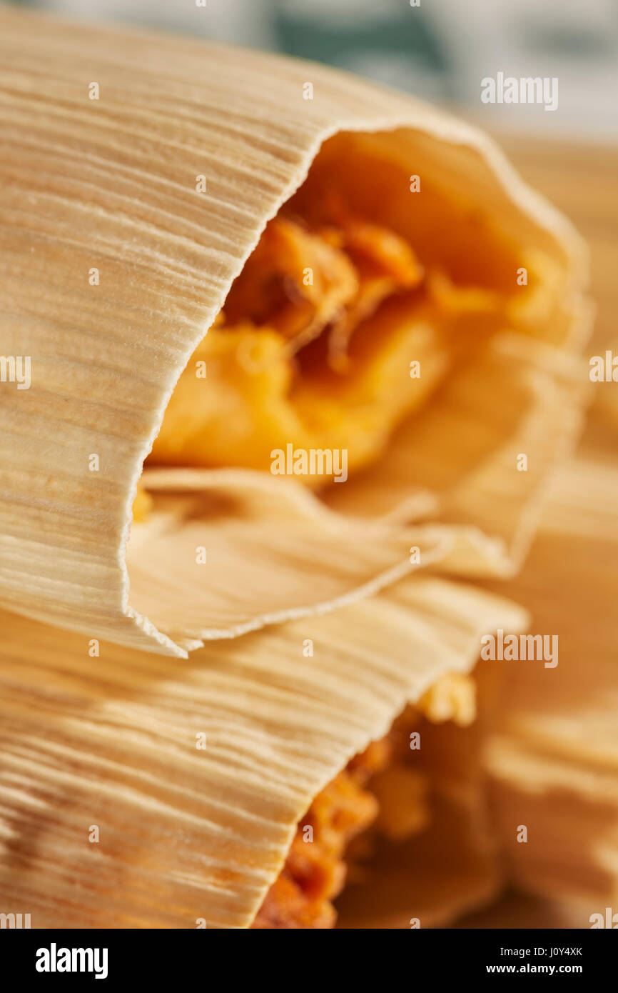 Mexican style tamales wrapped in dried corn husks Stock Photo