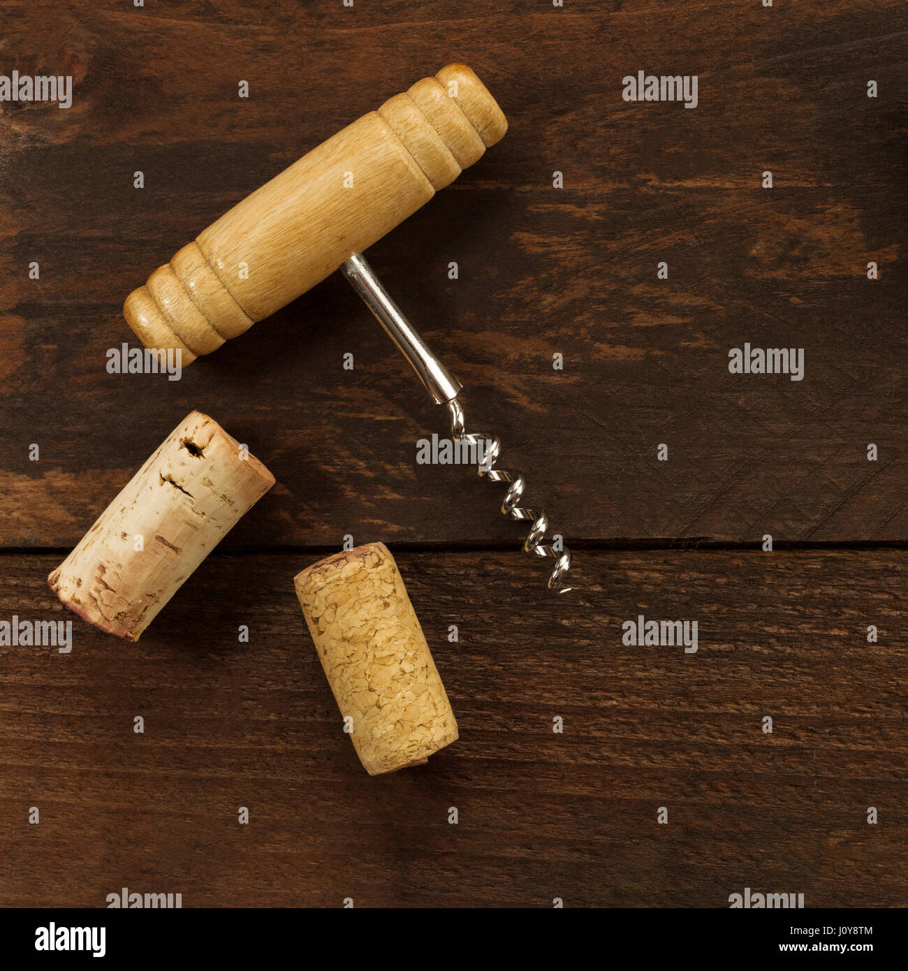 A photo of an old-fashioned corkscrew with corks, shot from above on a