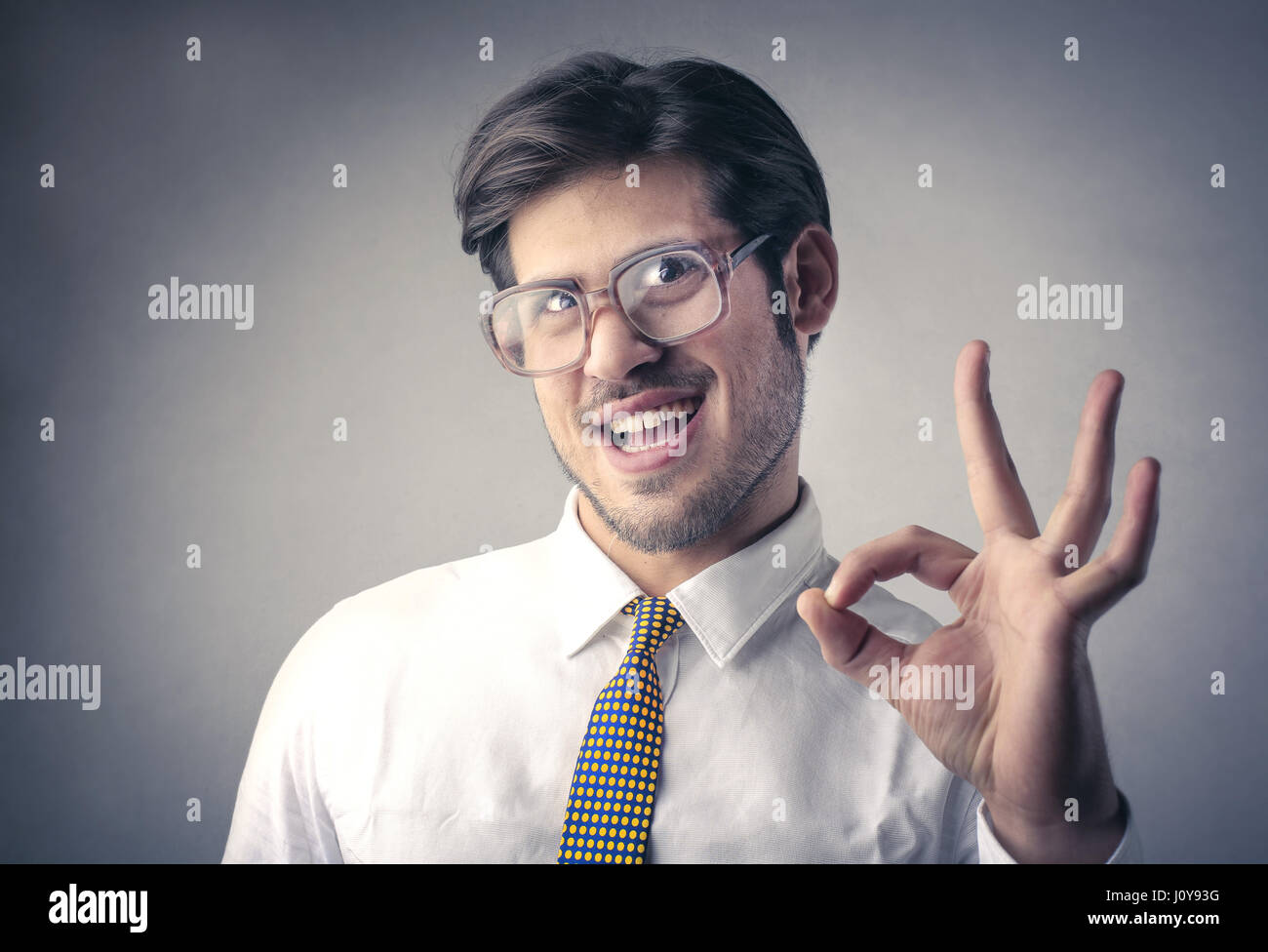Businessman making perfect sign Stock Photo