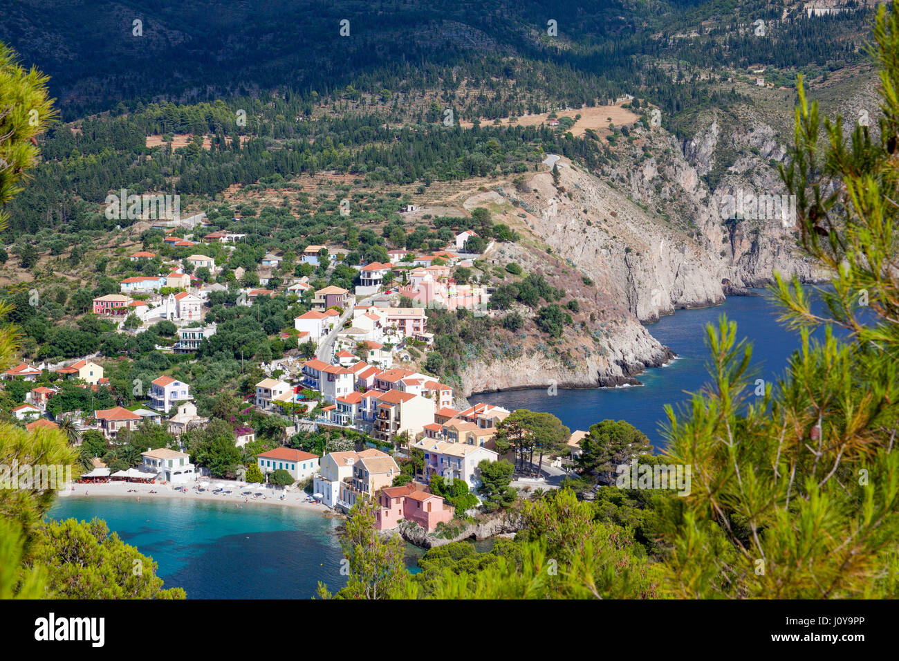 A view of the beach and accommodation in Assos on the island of Kefalonia in the Ionian Islands. Stock Photo