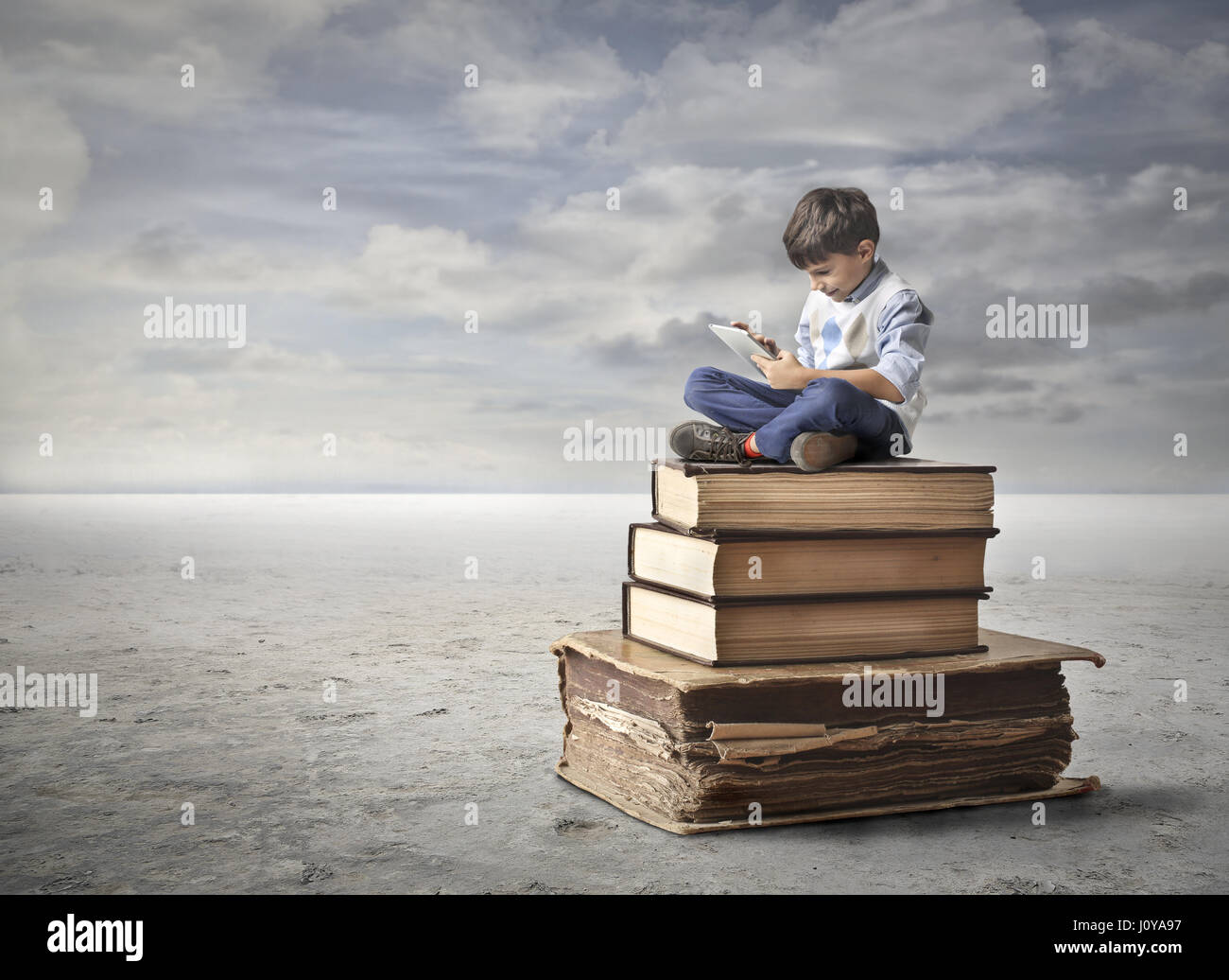 Little boy reading on huge books Stock Photo