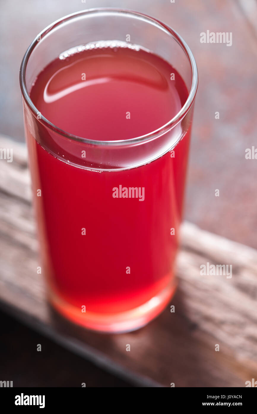 Drink bright red color in a transparent glass vertical Stock Photo