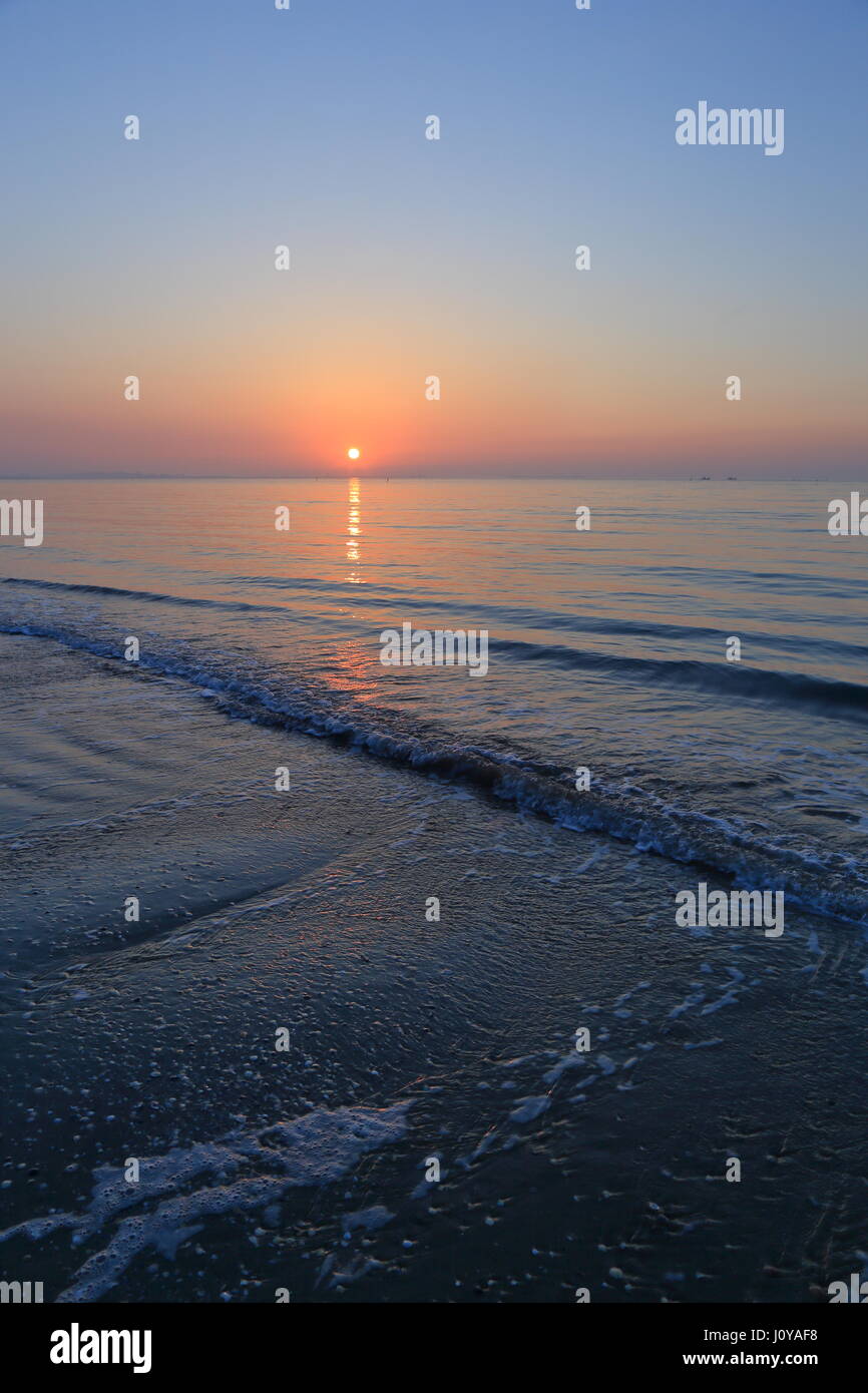 Venice, Italy, A spectacular sunrise over Lido di Venezia jetty at the begining of a day on the Adriatic coast. Sunrise time sequence. Stock Photo