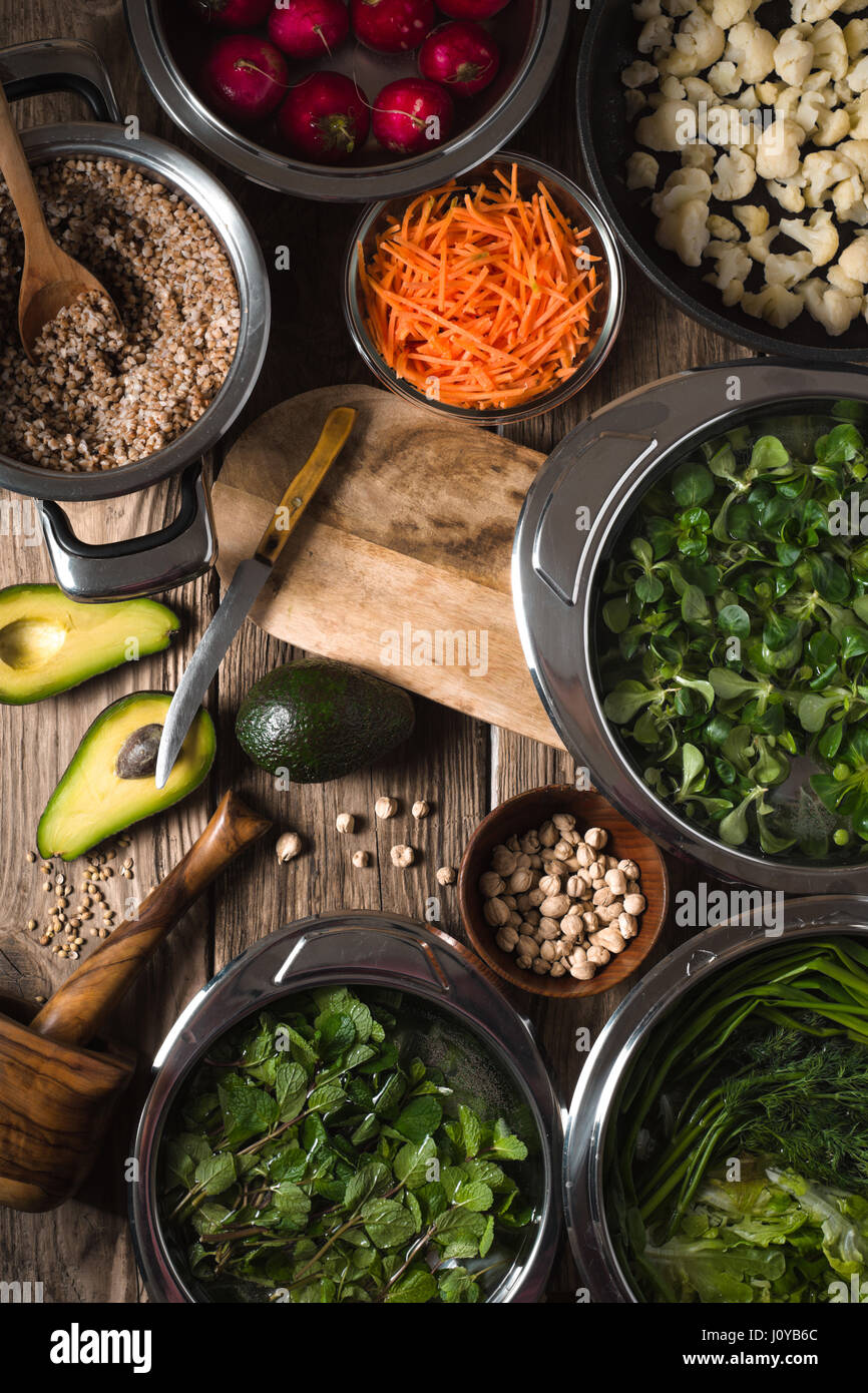 Vegetables in a bowl, chickpeas, avocado halves on the table vertical Stock Photo