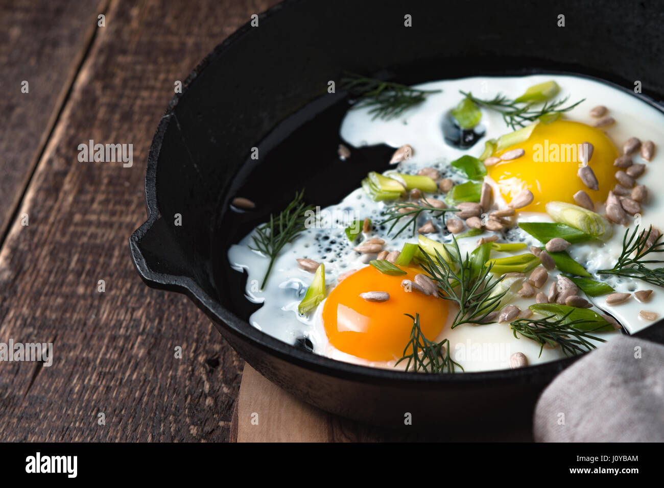 Scrambled eggs on the wooden table horizontal Stock Photo - Alamy