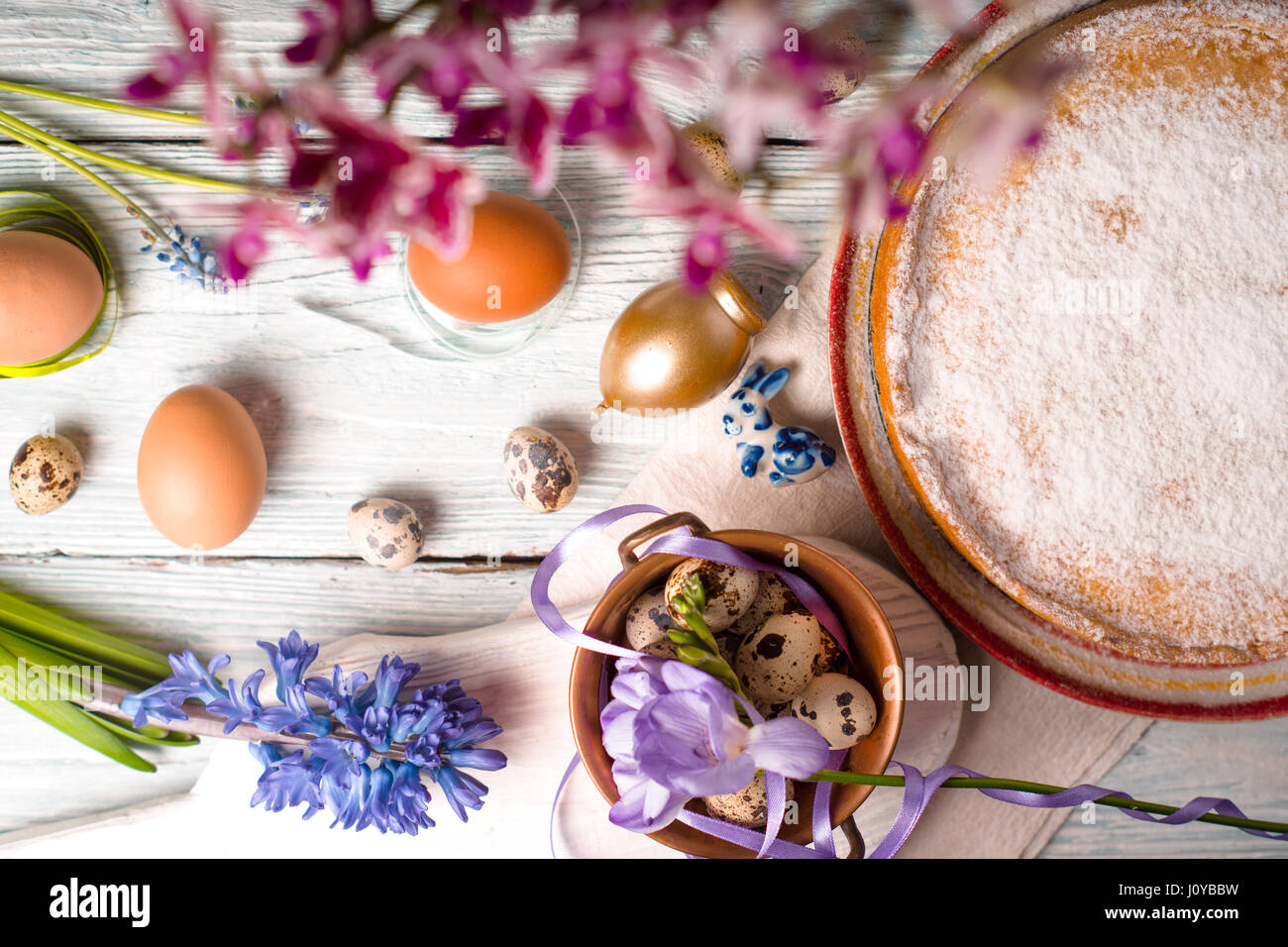 Easter decoration  , flowers and German Easter cake on the white wooden table top view Stock Photo