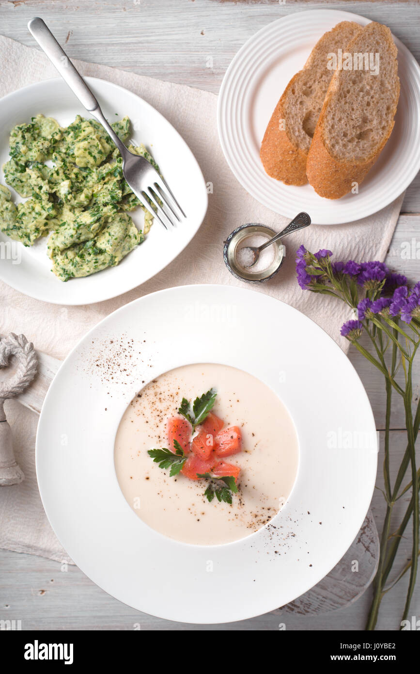 Vichyssoise soup and herb omelet on the white wooden table vertical Stock Photo