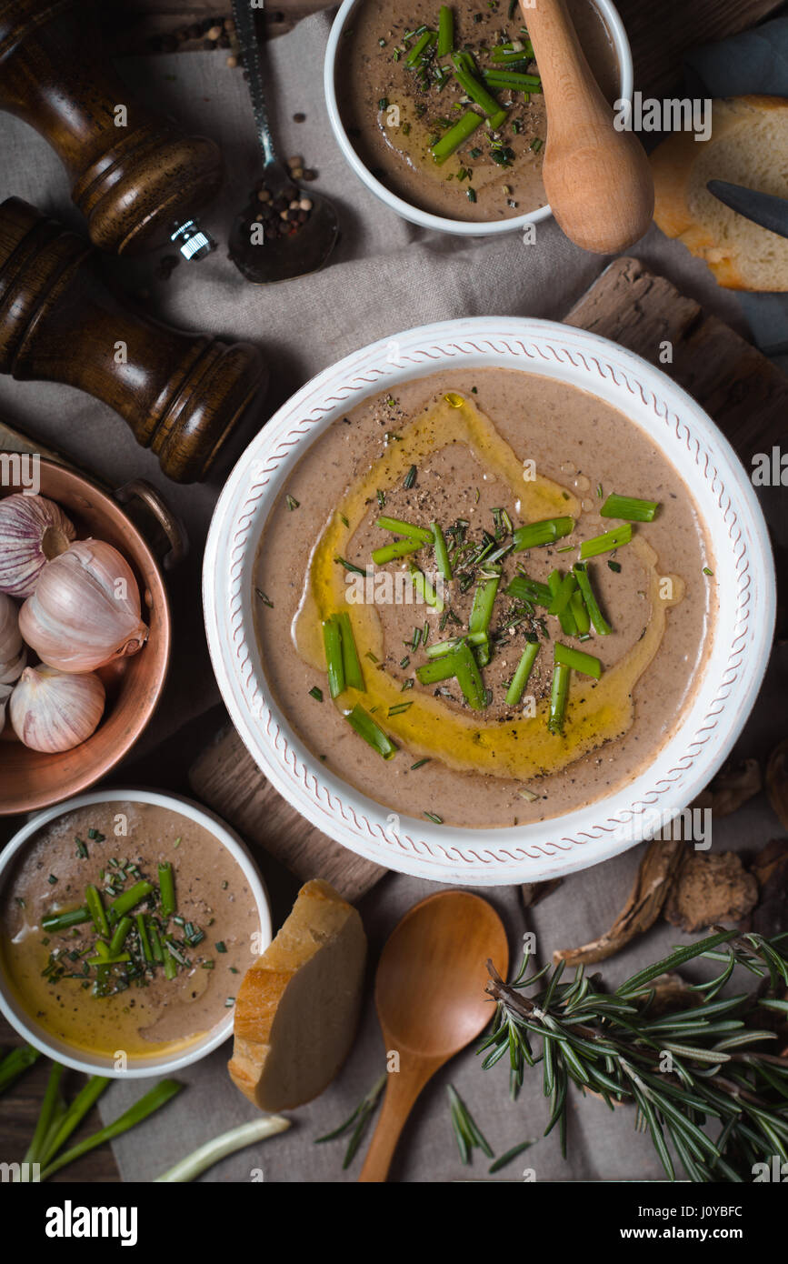 Mushroom cream soup on the rustic background top view Stock Photo