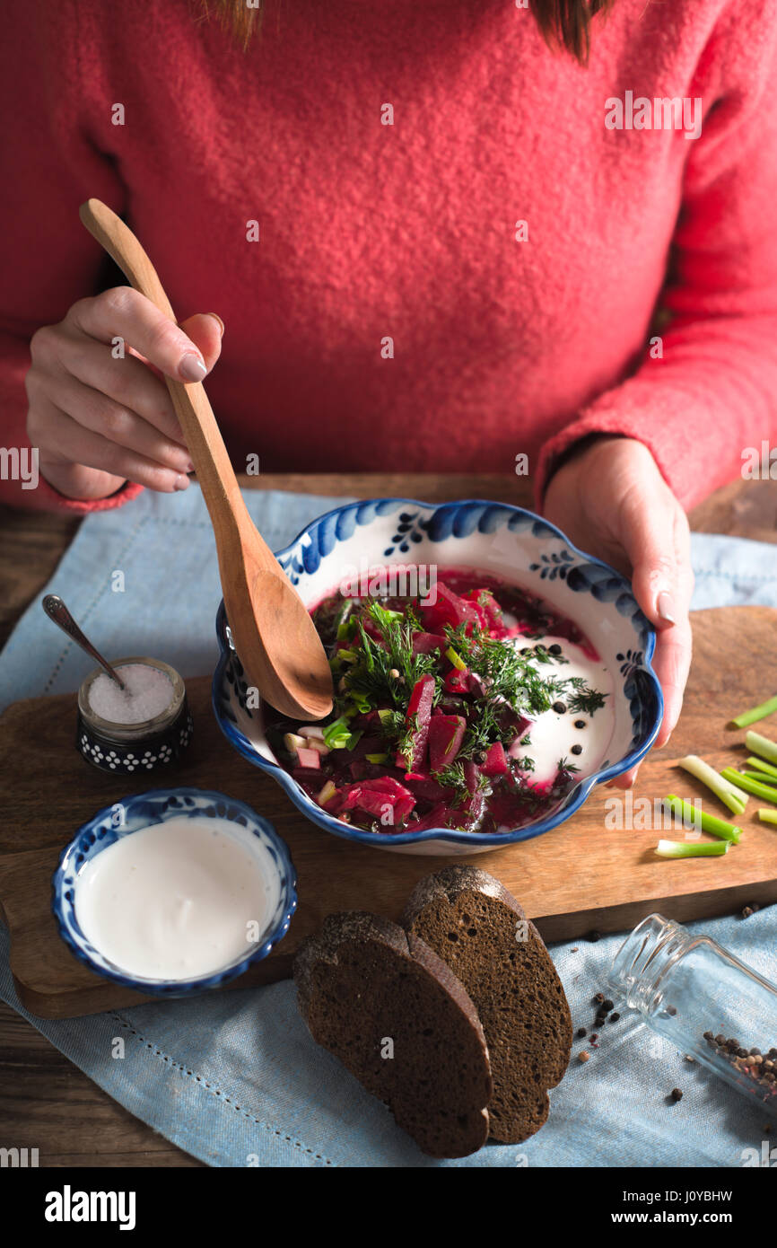 Woman eating traditional beetroot soup borsch vertical Stock Photo