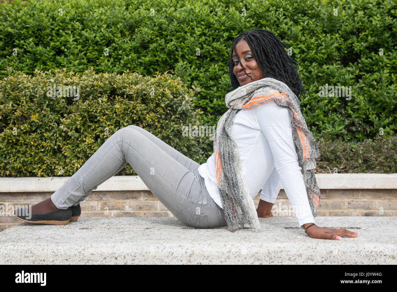 Seated african woman hi-res stock photography and images - Alamy
