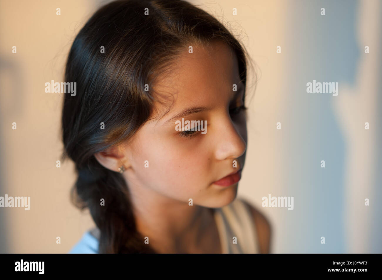 side portrait of an attractive young girl with a pigtail Stock Photo