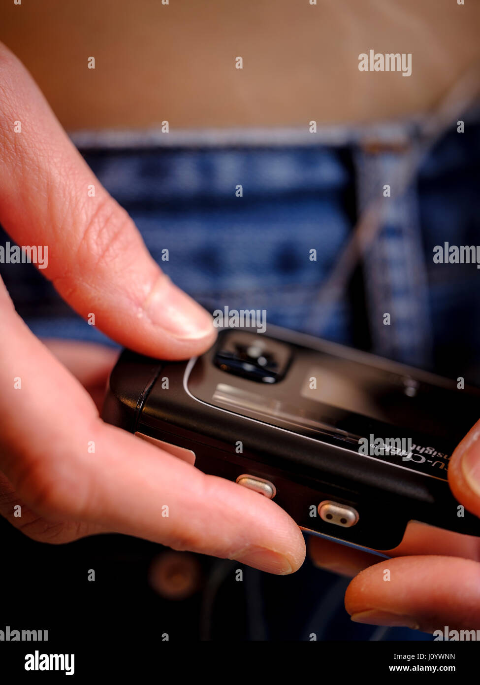 A woman with Type 1 diabetes using an insulin pump and continuous glucose monitor. Stock Photo