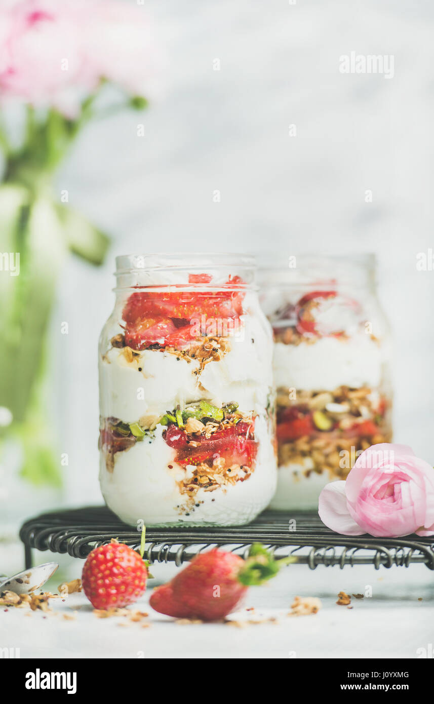 Greek yogurt, granola, fresh strawberry breakfast jars, pink raninkulus