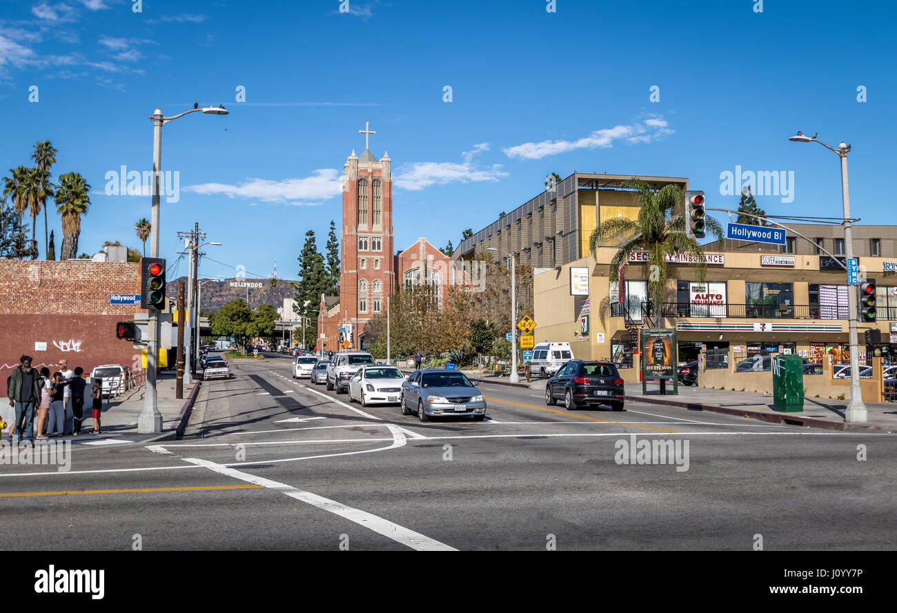 Hollywood Boulevard with the First Presbyterian Church of Hollywood and the Hollywood sign as background - Los Angeles, California, USA Stock Photo