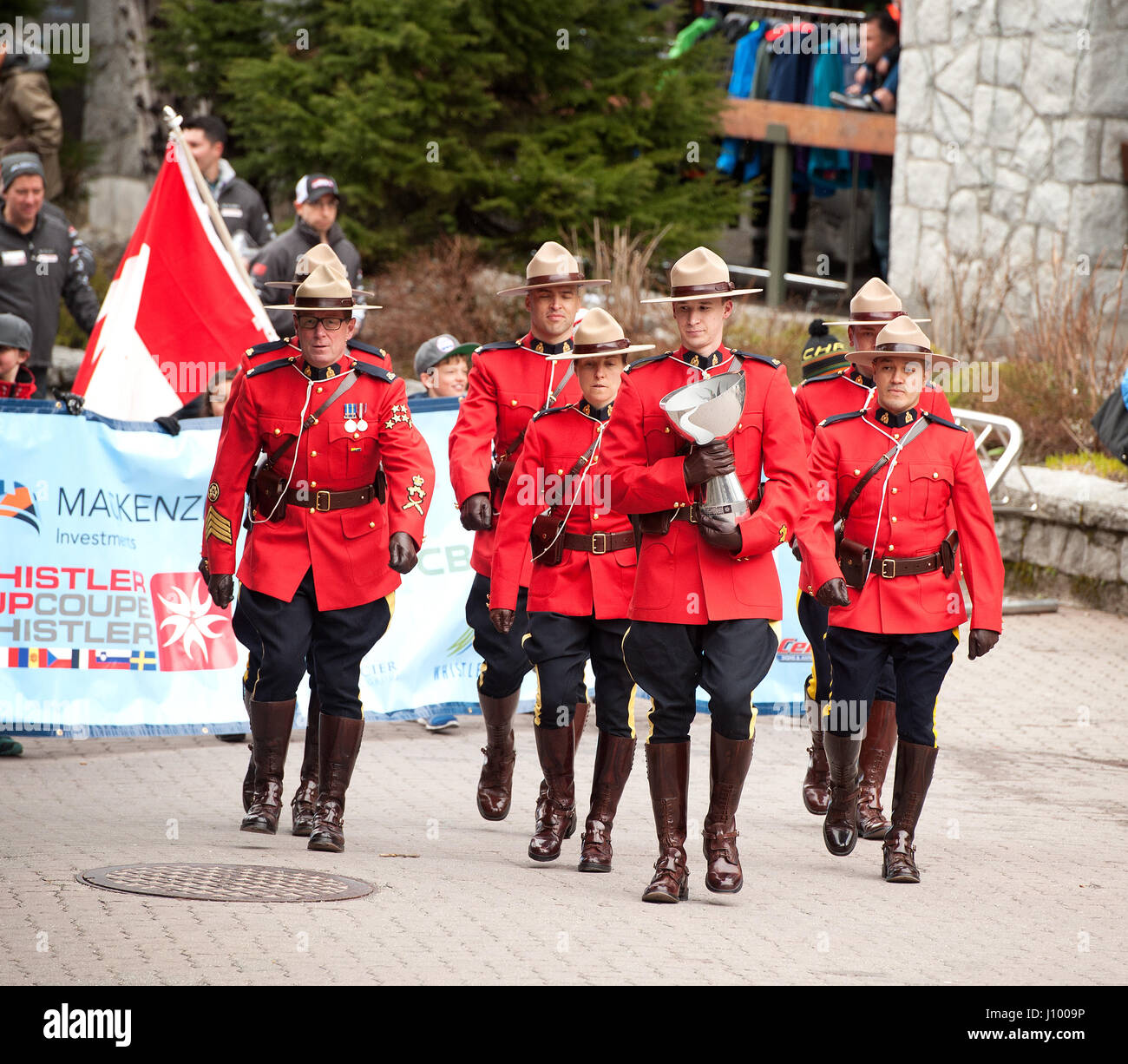 Royal Canadian Mounted Police, or RCMP officers in traditional dress red serge uniforms parade during the Canada Cup.  Whistler BC, Canada. Stock Photo