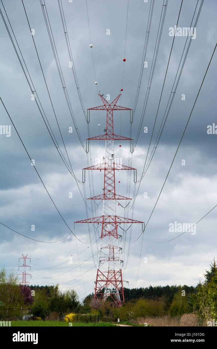 Pylon of high voltage transmission line. Cloudy sky in background. Stock Photo