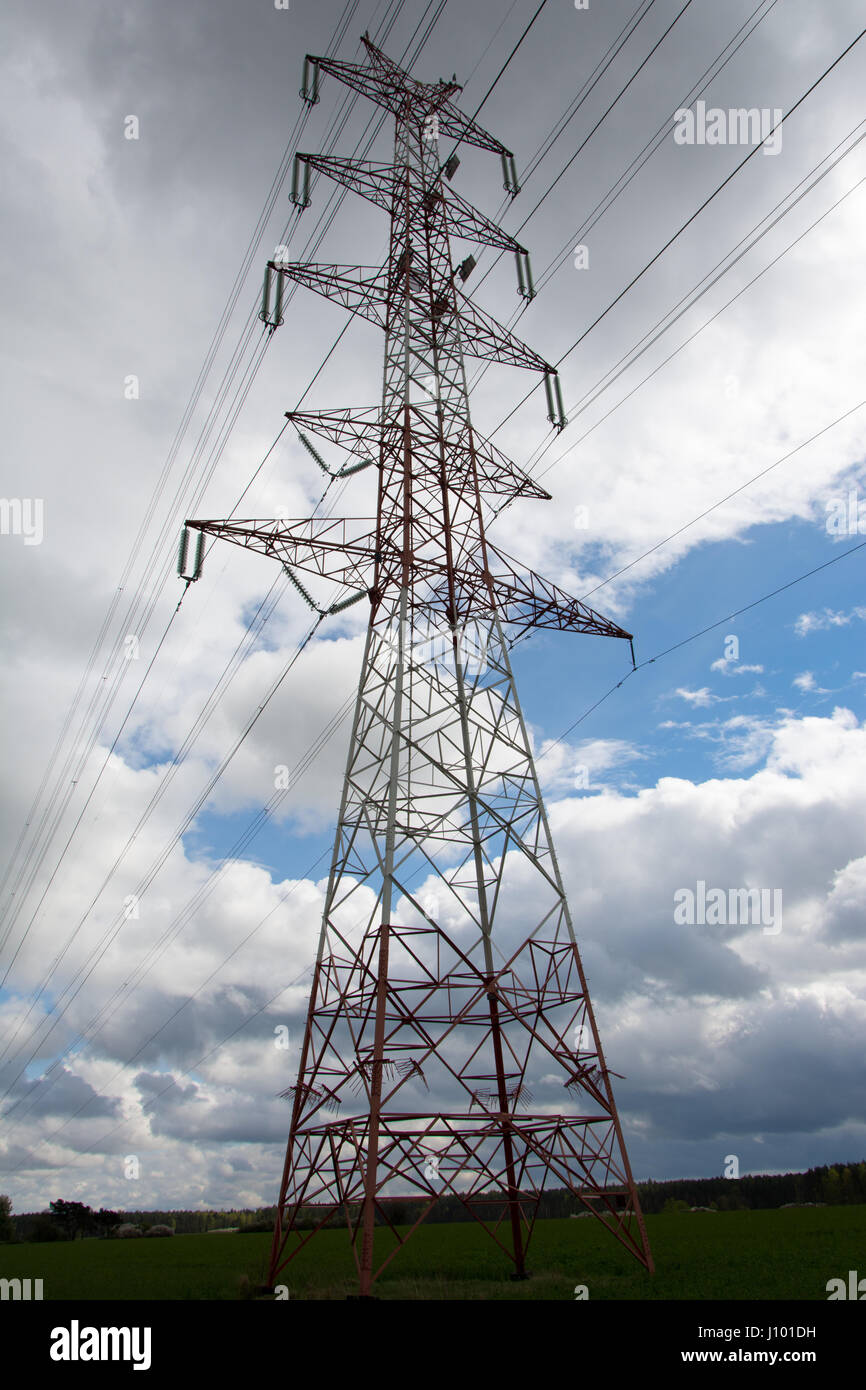 Pylon of high voltage transmission line. Cloudy sky in background. Stock Photo