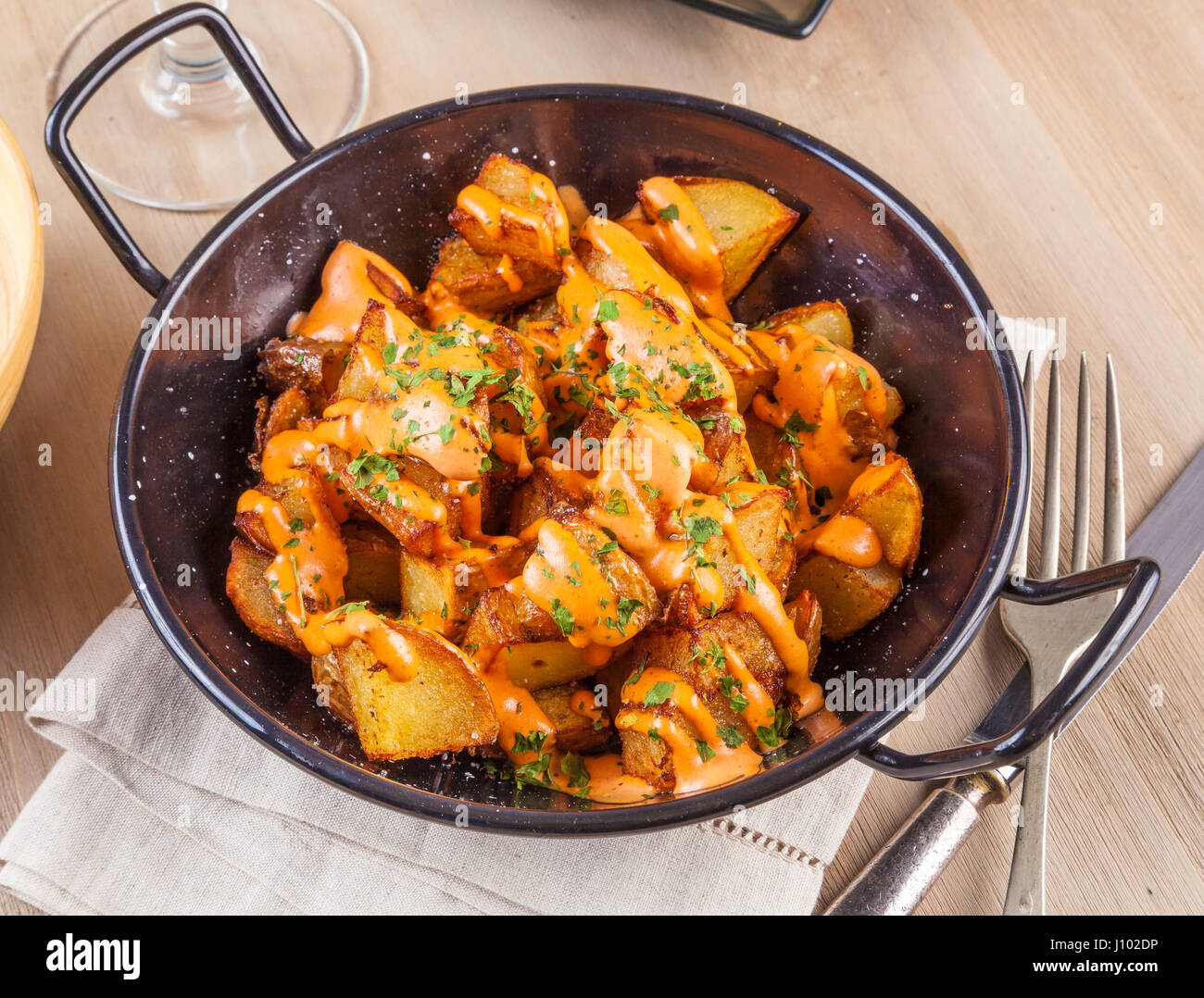 Patatas bravas, spicy potatoes, a typical Spanish dish with fried