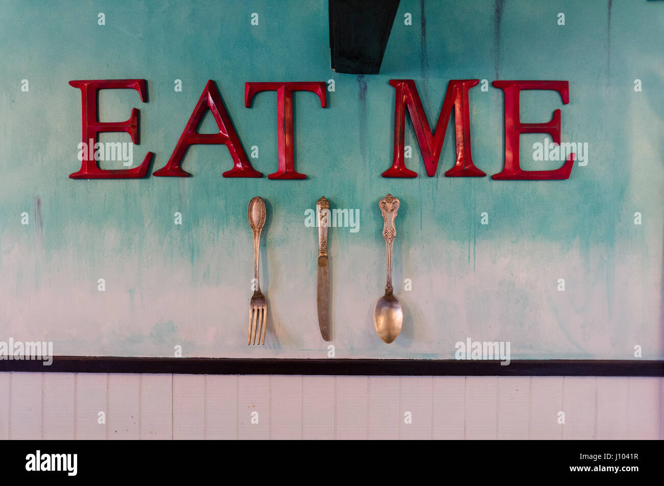 'Eat me' sign on a wall Stock Photo