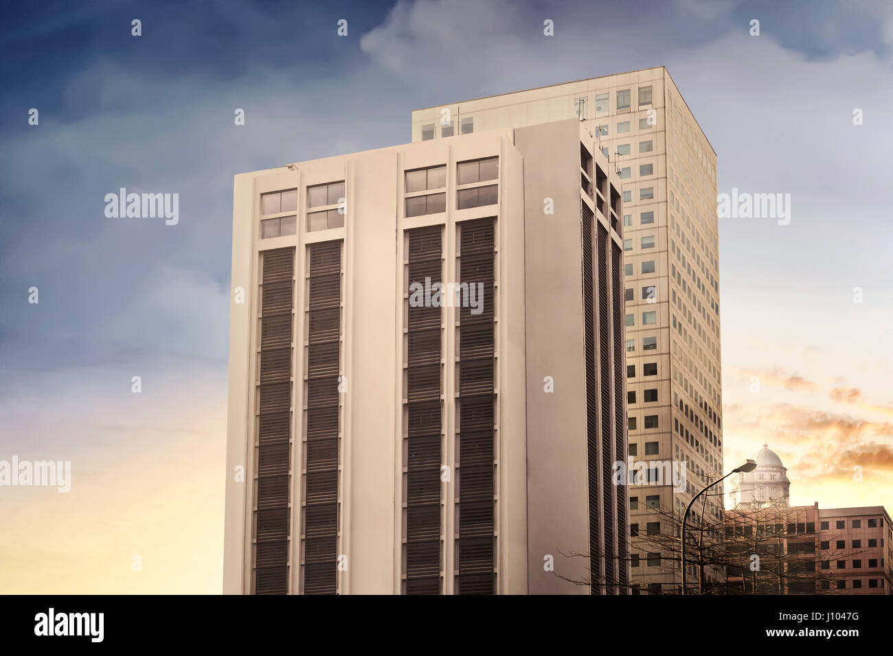 Stylized modern office building architecture in the city at sunset ...