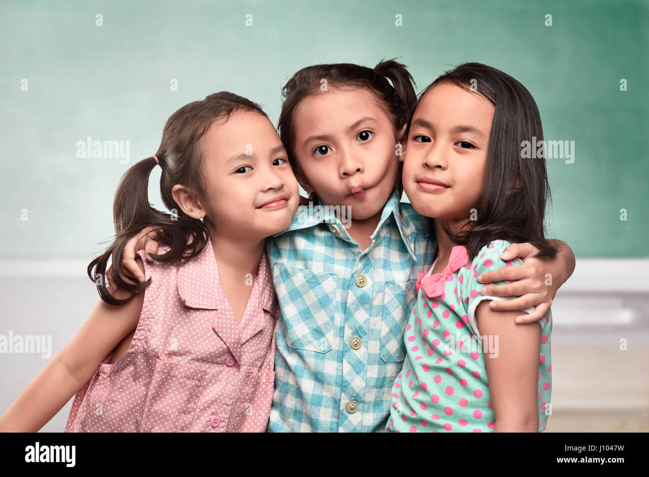Group of asian kids with funny expression standing in front of the ...