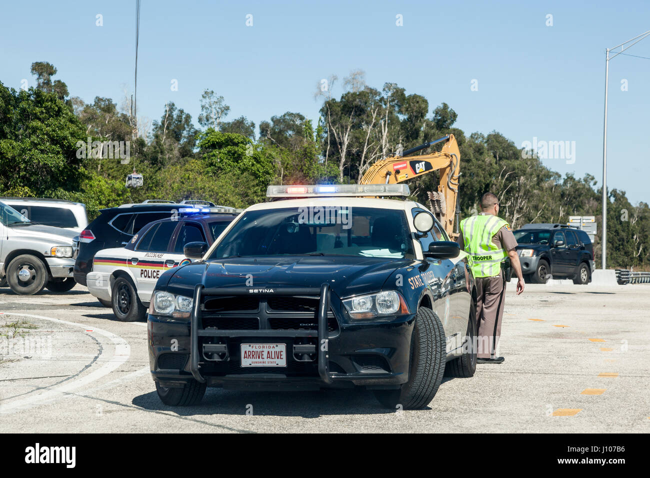 Miami, Fl, USA - March 21, 2017: Police car and officers at the highway interection in Miami. Florida, United States Stock Photo