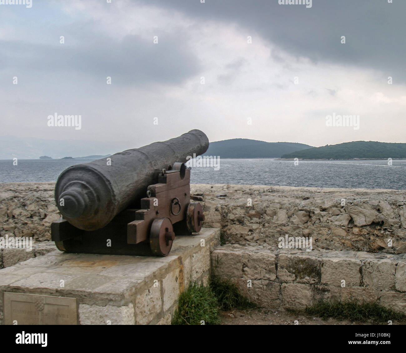Korcula, Croatia. 9th Oct, 2004. An ancient cannon in the medieval fortified Old Town of Korcula, Croatia, look out on the Peljeski Kanal, where several historic battles occurred, toward the mainland. Korcula has become an international tourist destination. Credit: Arnold Drapkin/ZUMA Wire/Alamy Live News Stock Photo