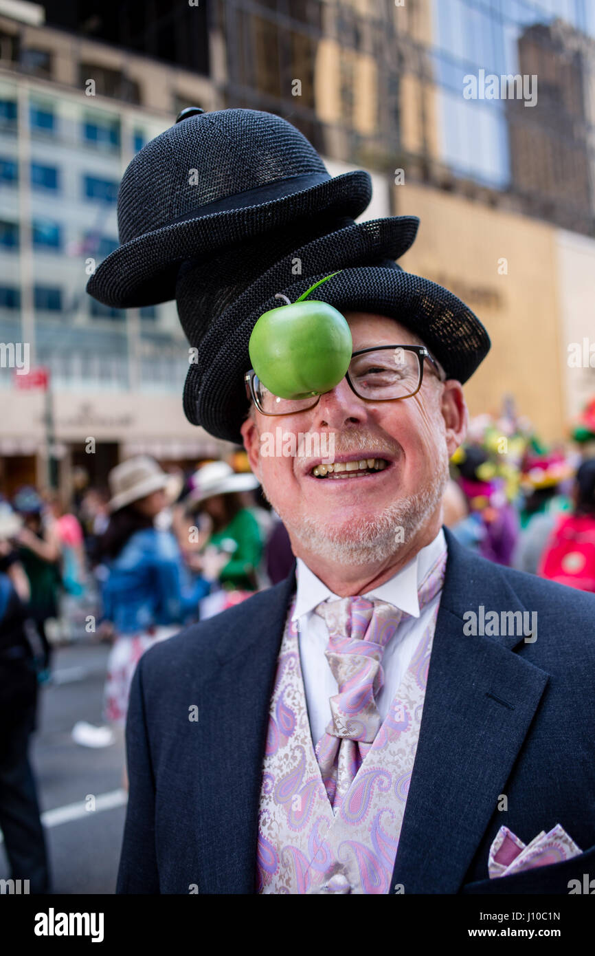 New York, USA. 16th Apr, 2017. A man wears a stack of bowler hats and a  green apple, and looks like Rene Magritte's 1946 painting The Son of Man at  New York's
