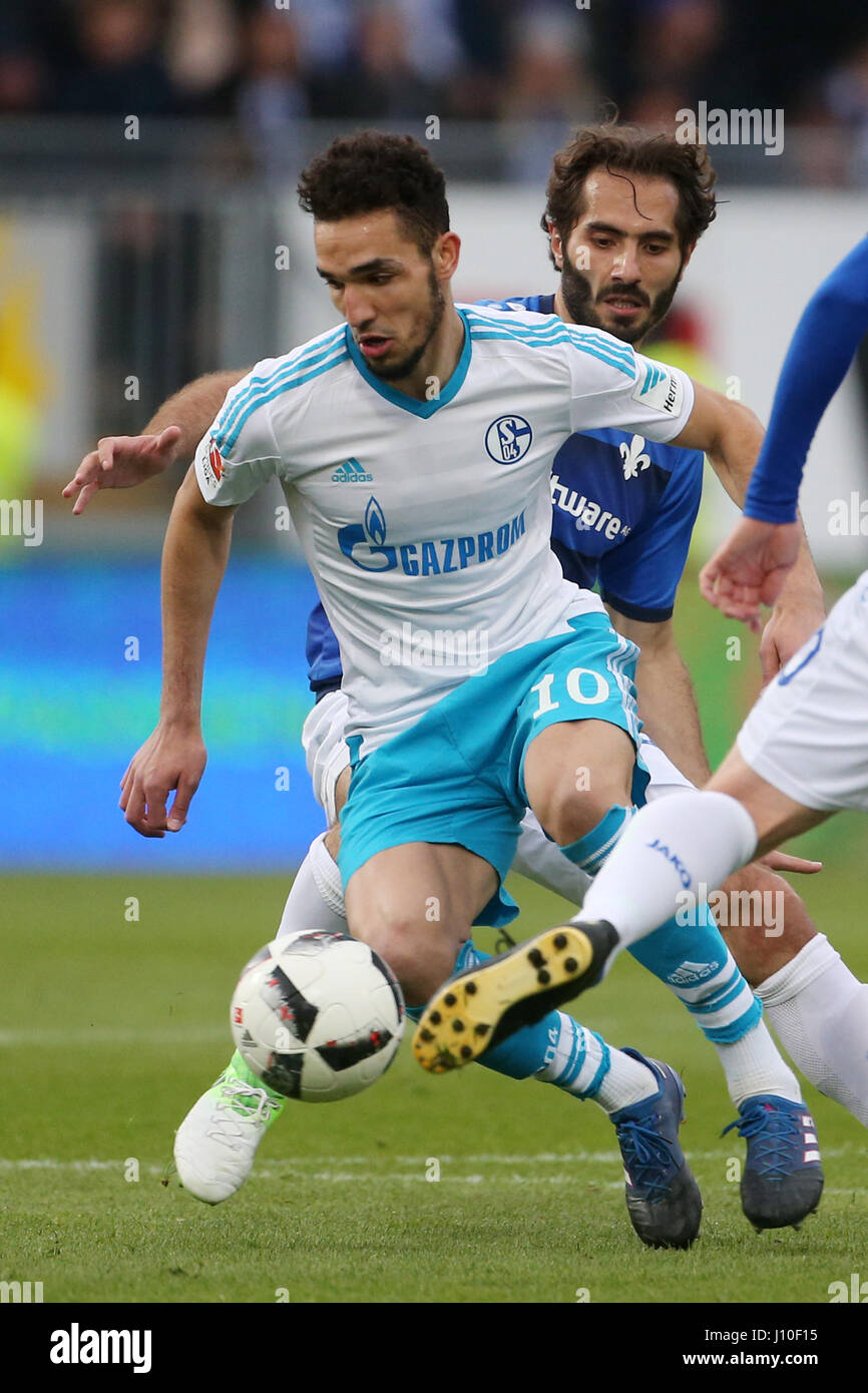 Schalke's Nabil Bentaleb (L) and Darmstadt's Hamit Altintop (R) fight for the ball during the German Bundesliga soccer match between Darmstadt 98 and FC Schalke 04 in the Jonathan Heimes Stadium in Darmstadt, Germany, 16 April 2017. Photo: Thomas Frey/dpa Stock Photo