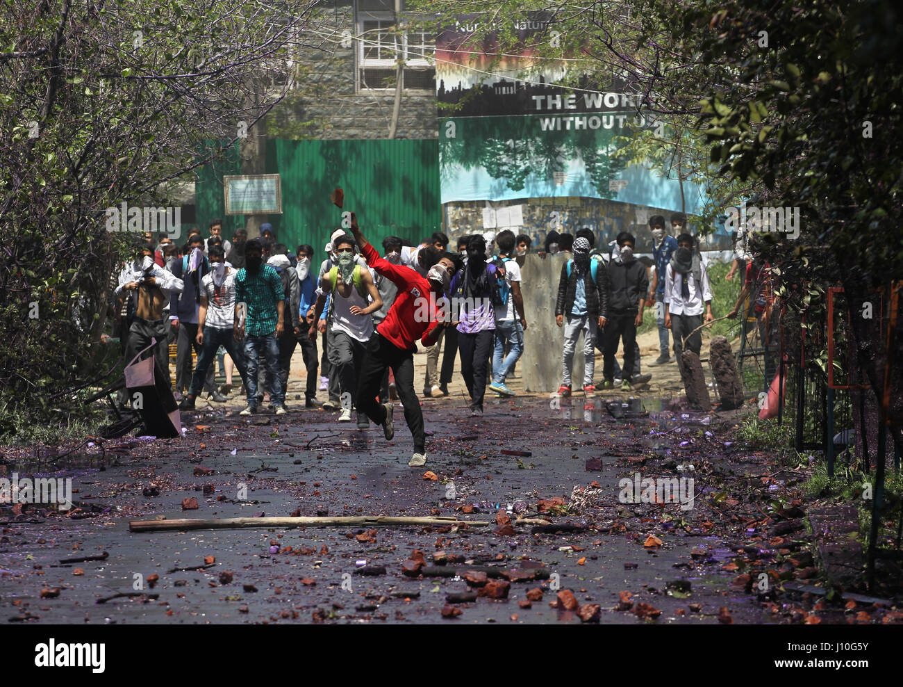 Srinagar, Kashmir. 17th Apr, 2017. Kashmiri students throw bricks and