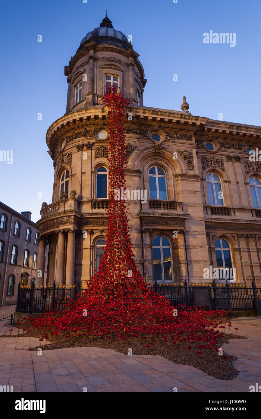 Hull, East Yorkshire, UK. 17th April 2017. Poppies: Weeping Window by Paul Cummins artist and Tom Piper designer. A cascade of several thousand handmade ceramic poppies installed at Hull’s Maritime Museum. Photographed before sunrise. Credit: LEE BEEL/Alamy Live News Stock Photo