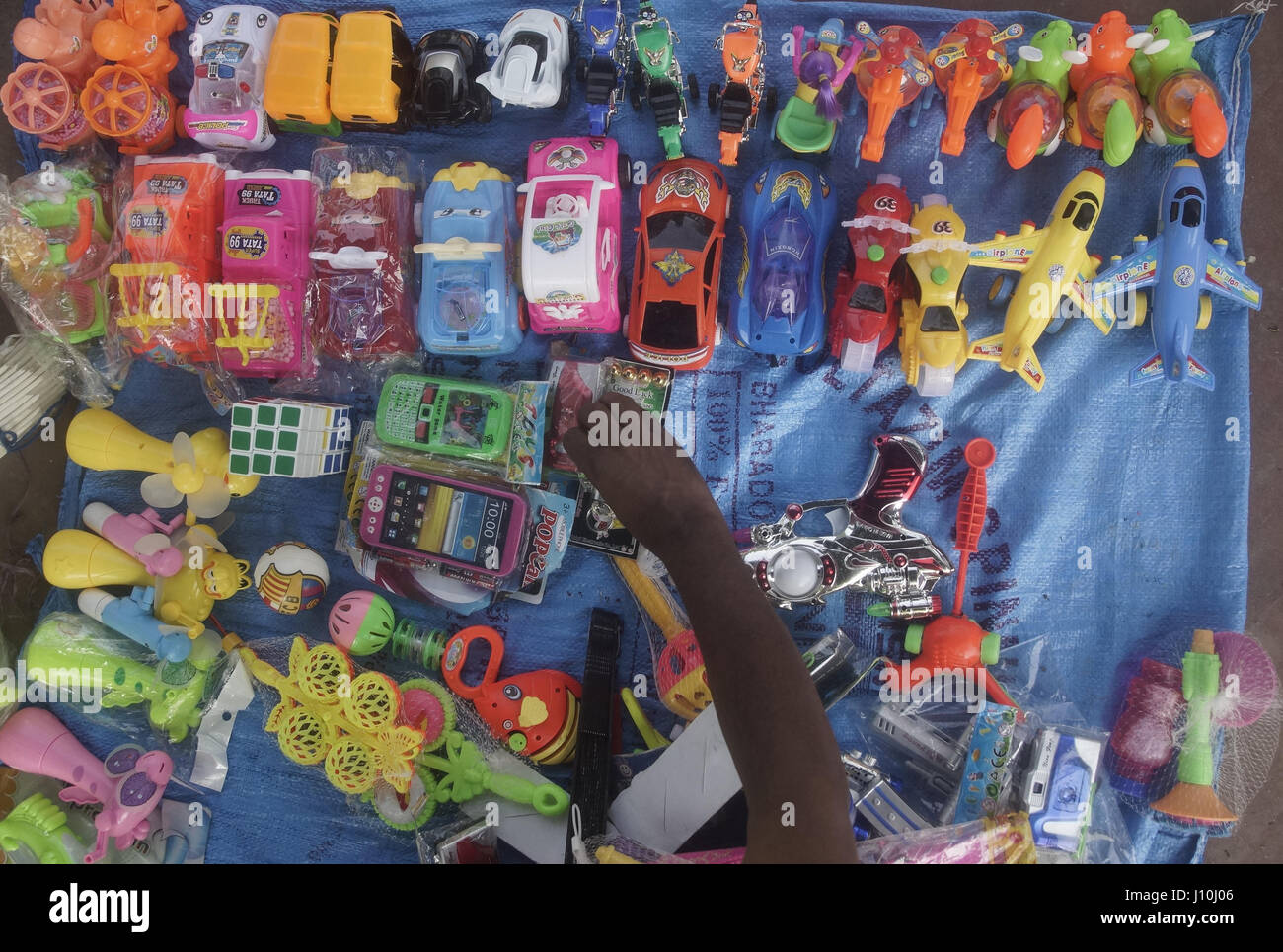Dhaka, Bangladesh. 17th Apr, 2017. A street vendor set up his toy store