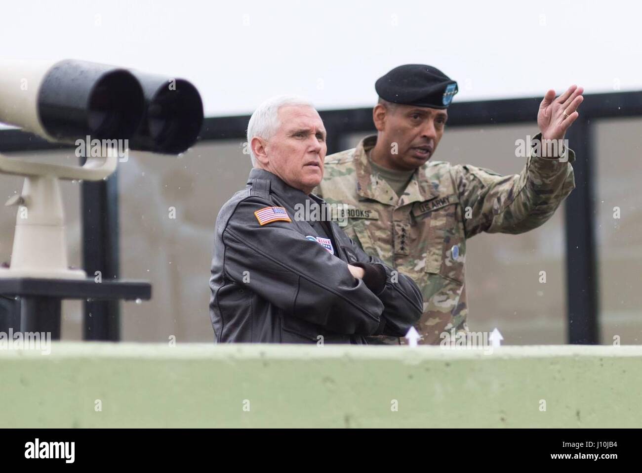 U.S. Vice President Mike Pence, left, looks out at the Demilitarized Zone with U.S. Army Gen. Vincent K. Brooks, commander of U.S and U.N. Forces in Korea at Freedom House during a visit to the DMZ April 17, 2017 in Panmunjom, South Korea. Stock Photo