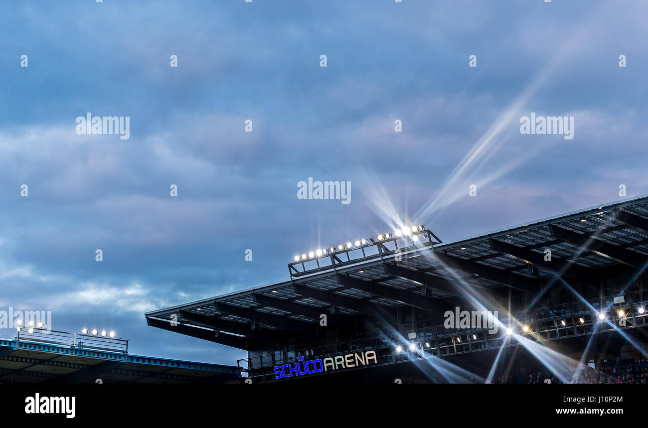 The floodlights shine bright against the darkening sky during the 2nd Bundesliga soccer match between Arminia Bielefeld and VfB Stuttgart in the Schueco Arena stadium in Bielefeld, Germany, 17 April 2017. Photo: Guido Kirchner/dpa Stock Photo