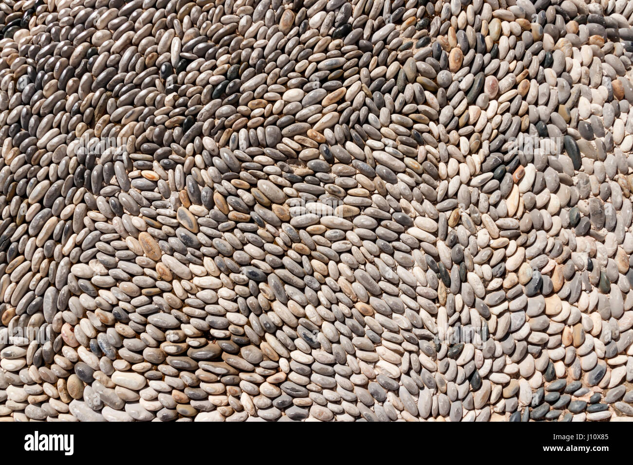 Background of lined small gray stones Stock Photo - Alamy