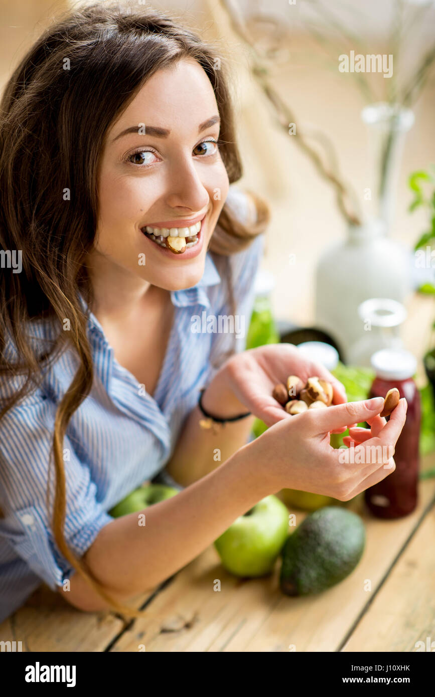Woman eating nuts Stock Photo