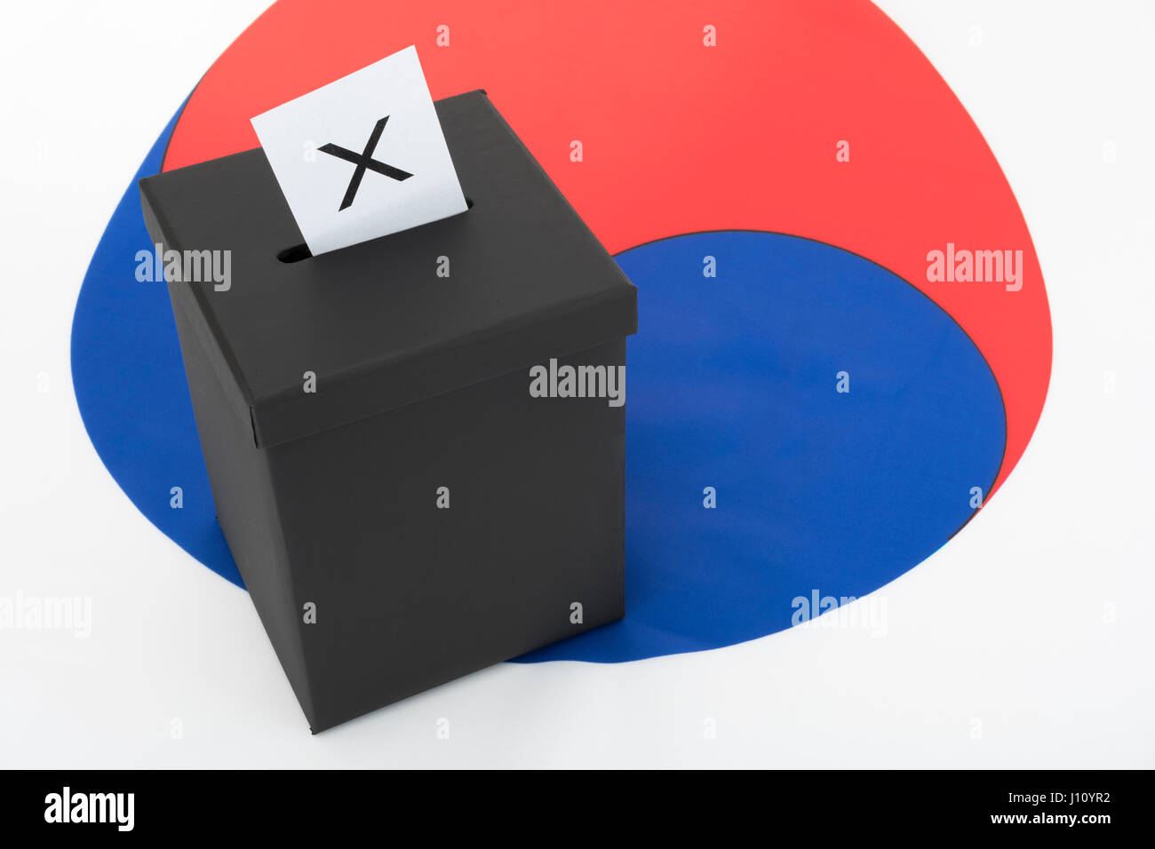 Replica black election ballot box set against South Korean flag