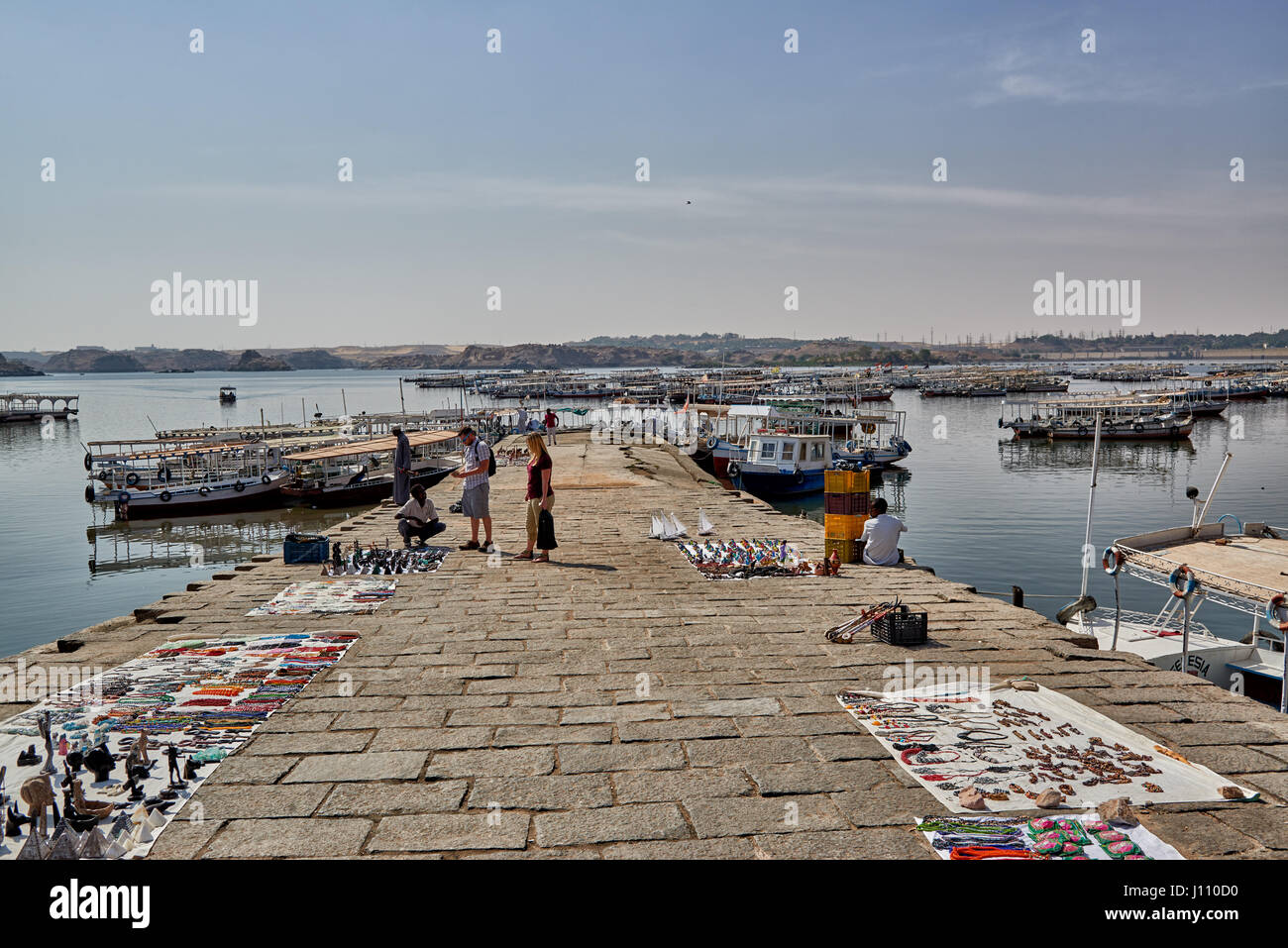 Traders and boats on jetty are waiting for tourists to Philae, Aswan , Egypt, Africa Stock Photo