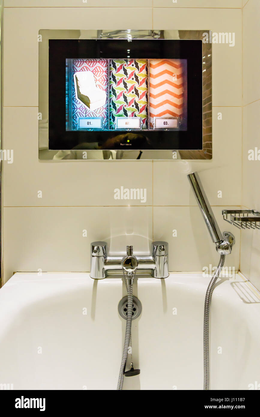 TV mounted into the wall above a bath in a luxury bathroom Stock Photo ...