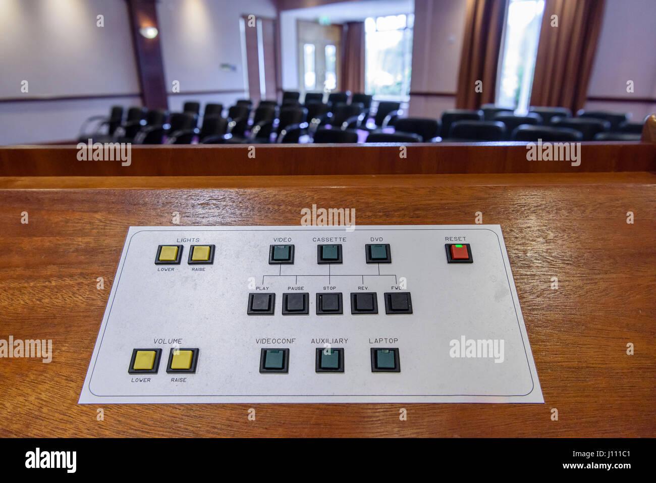 Audio Visual controls on the podium in a hotel conference room. Stock Photo