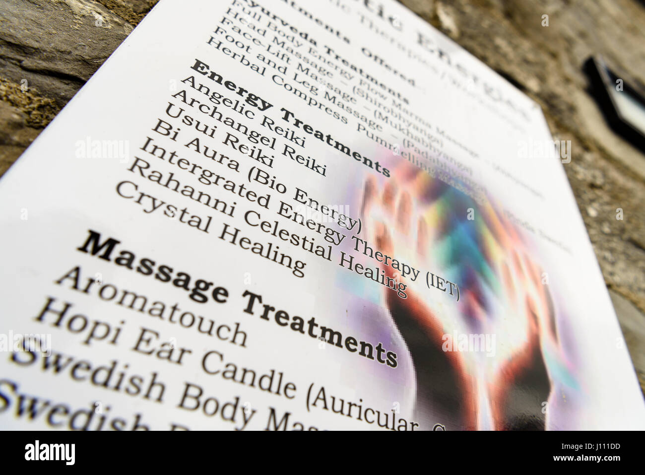 Sign at a 'New Age Therapy Treatment' centre, offering herbal, spiritual and cosmic energy treatments. Stock Photo