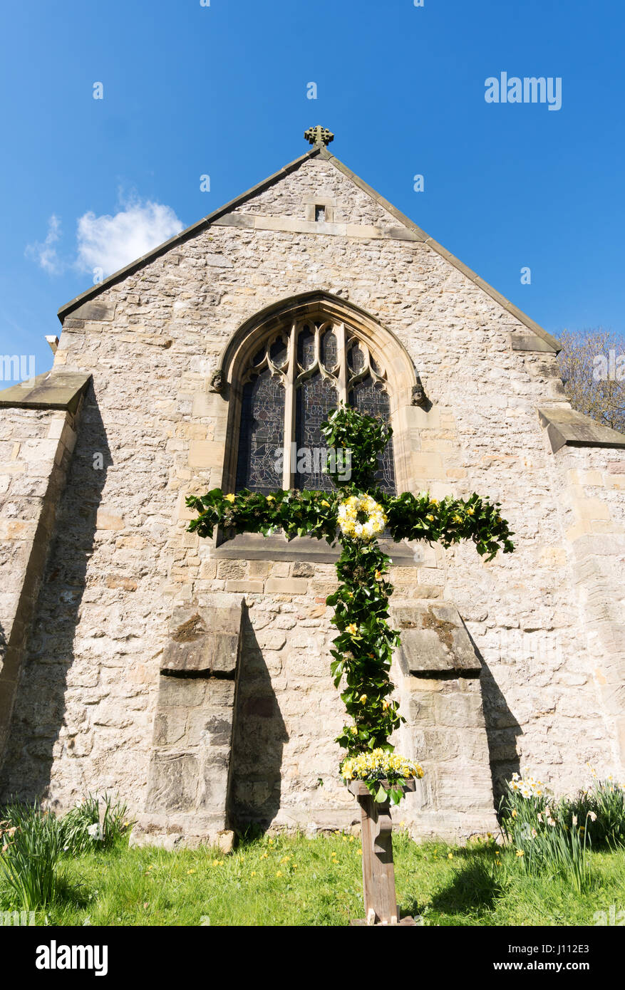 Cross decorated for Easter, Whitburn Parish church, South Tyneside, England, UK Stock Photo