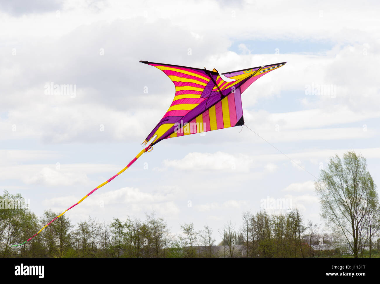 a coloured kite flies in the air Stock Photo Alamy
