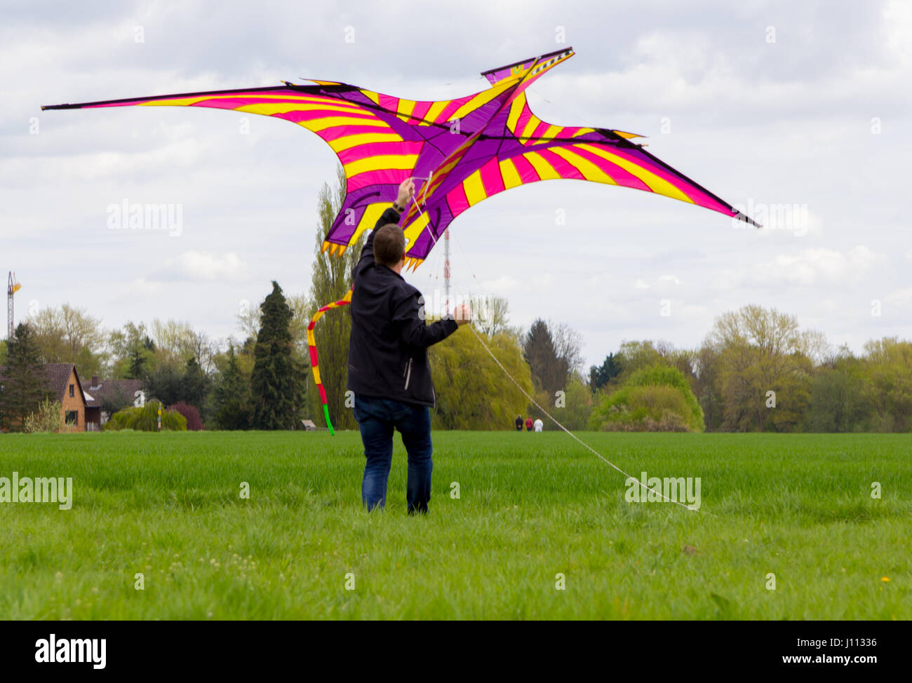 a man flies a coloured a kite Stock Photo Alamy