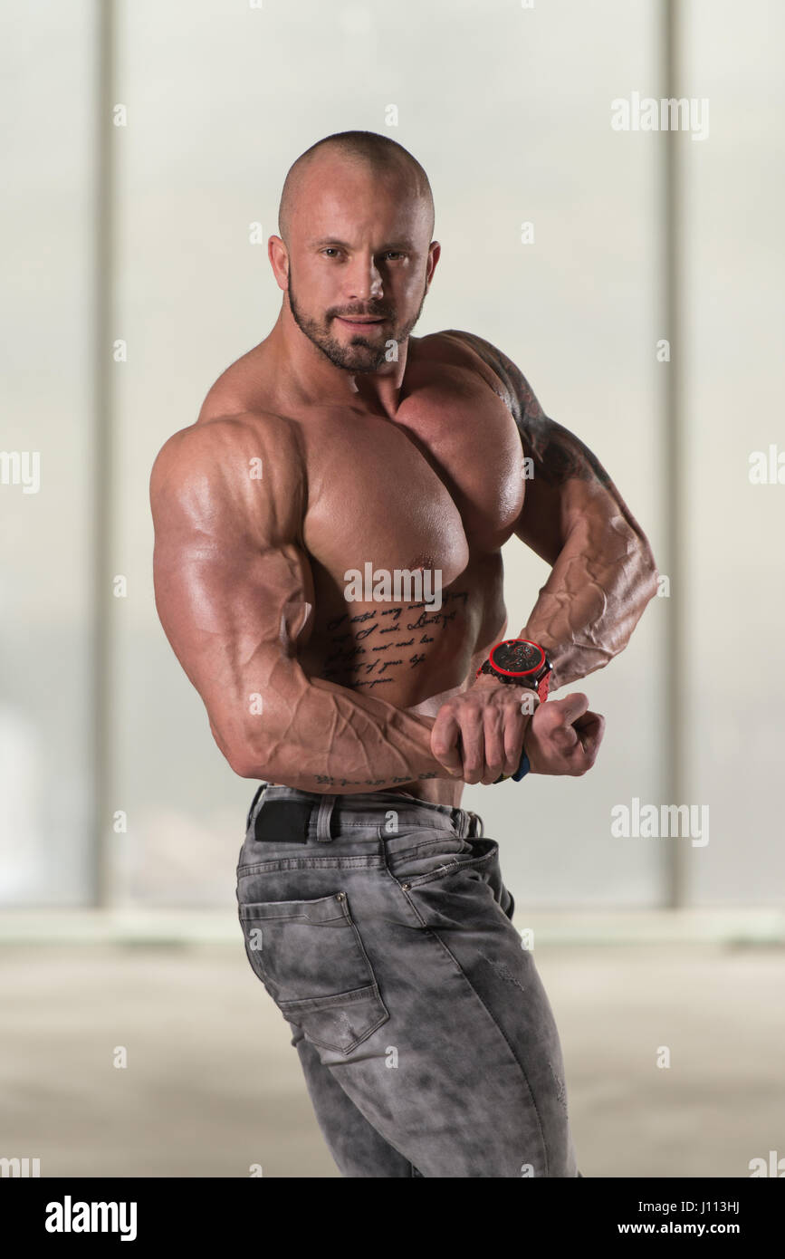 Portrait Of A Young Physically Fit Tattoo Man Showing His Well Trained Body - Muscular Athletic Bodybuilder Fitness Model Posing After Exercises Stock Photo - Alamy