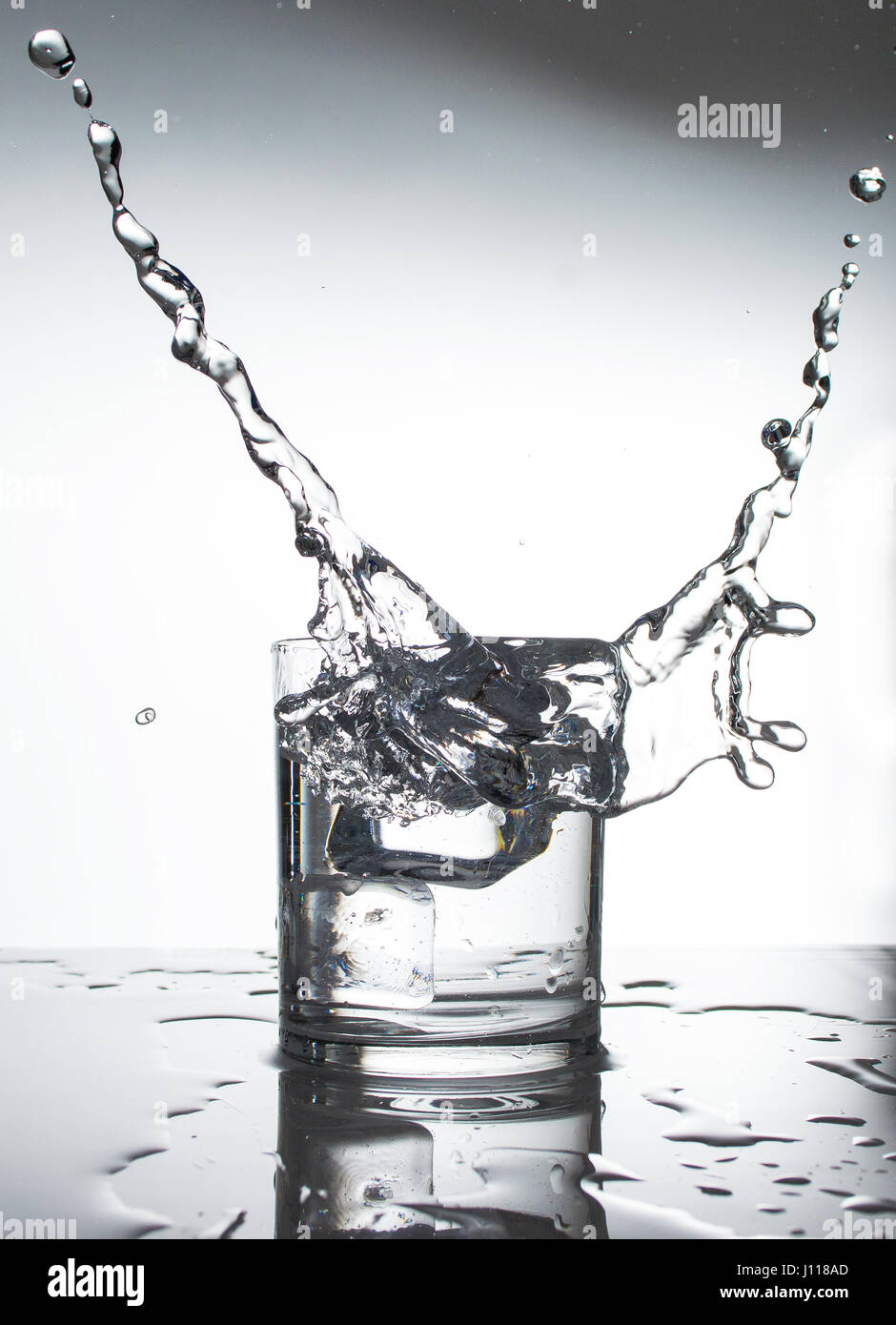 Fluid splashing in a whisky glass. Stock Photo
